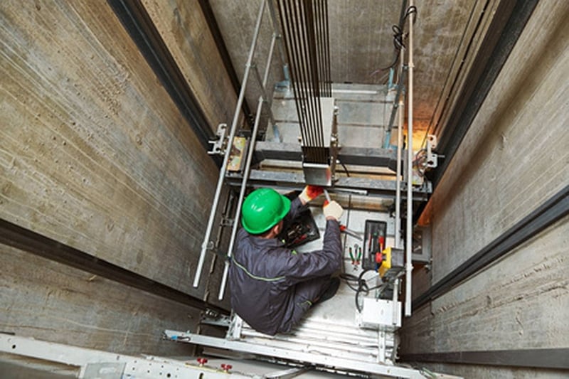 Engineer servicing an elevator shaft